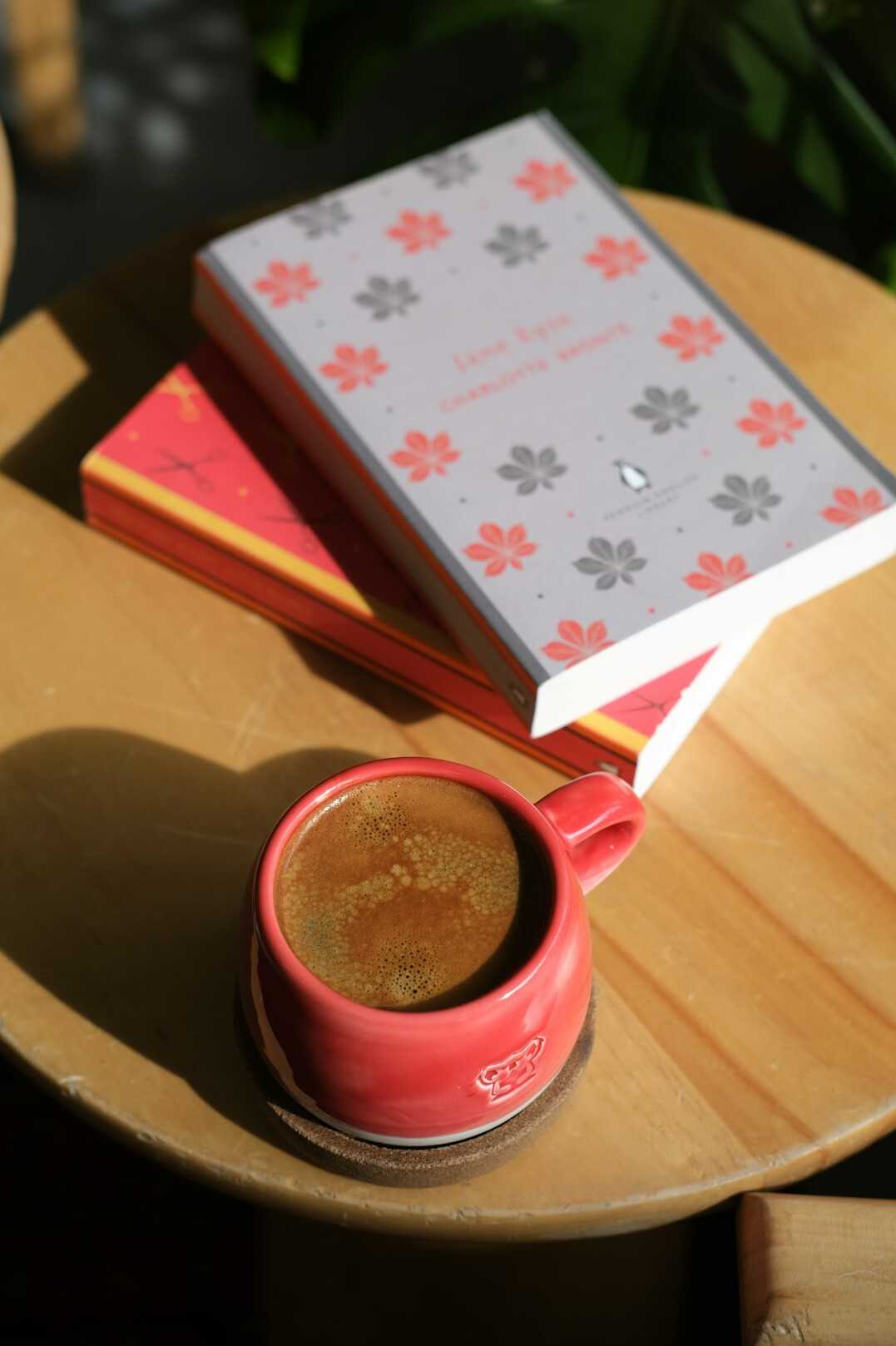 Stack of books and a cup of coffee on a table