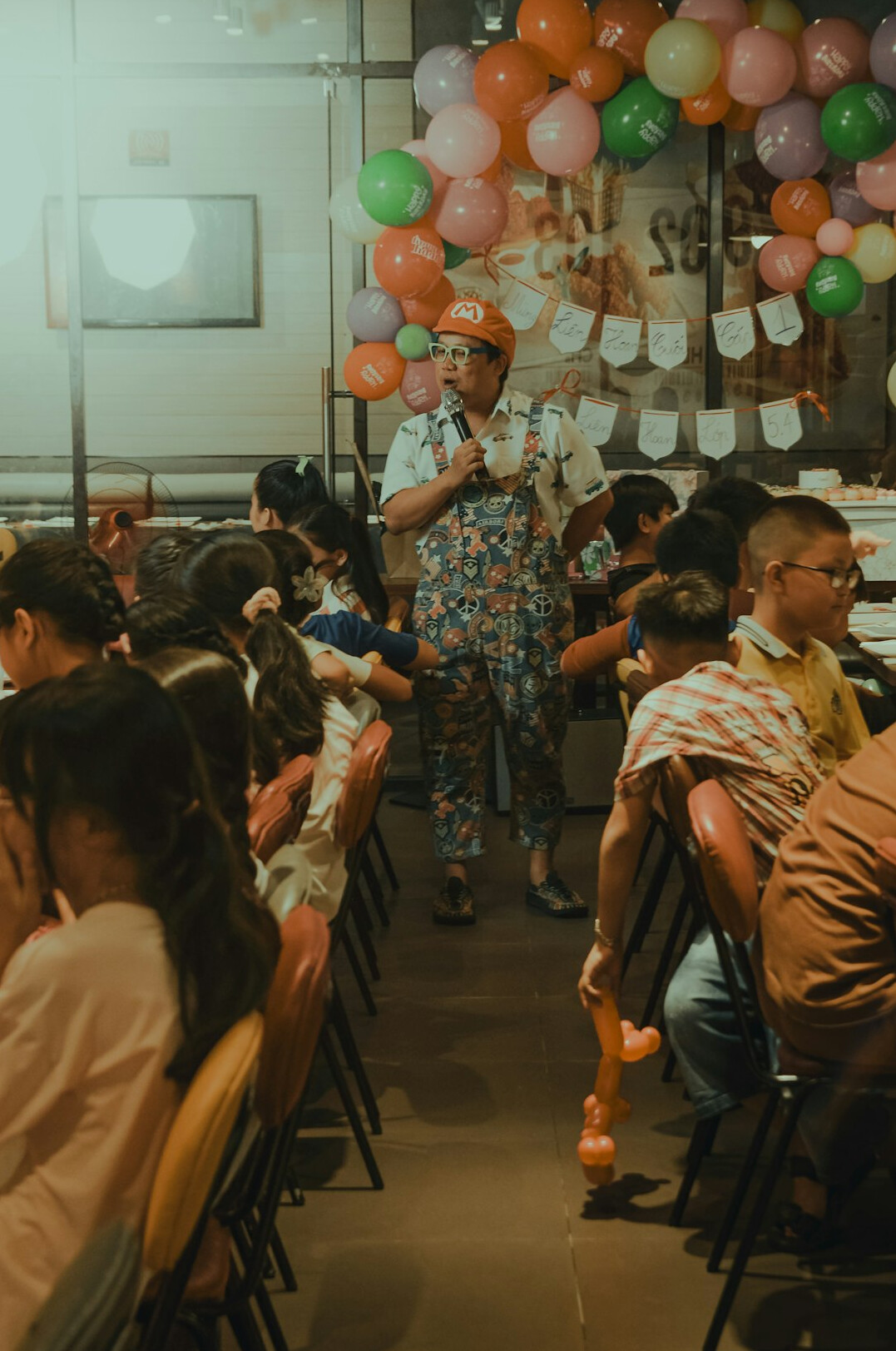 Person speaking confidently to a small seated audience