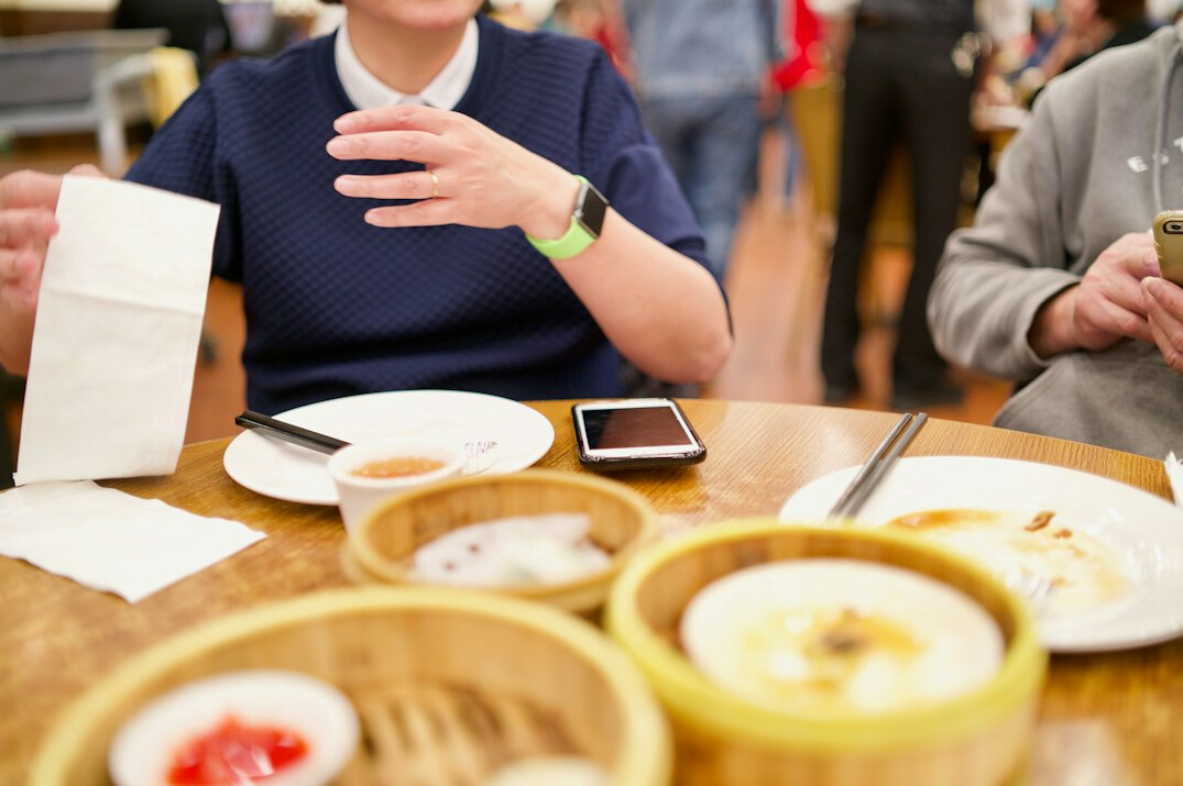 Two people in a mentoring conversation at a table with notes
