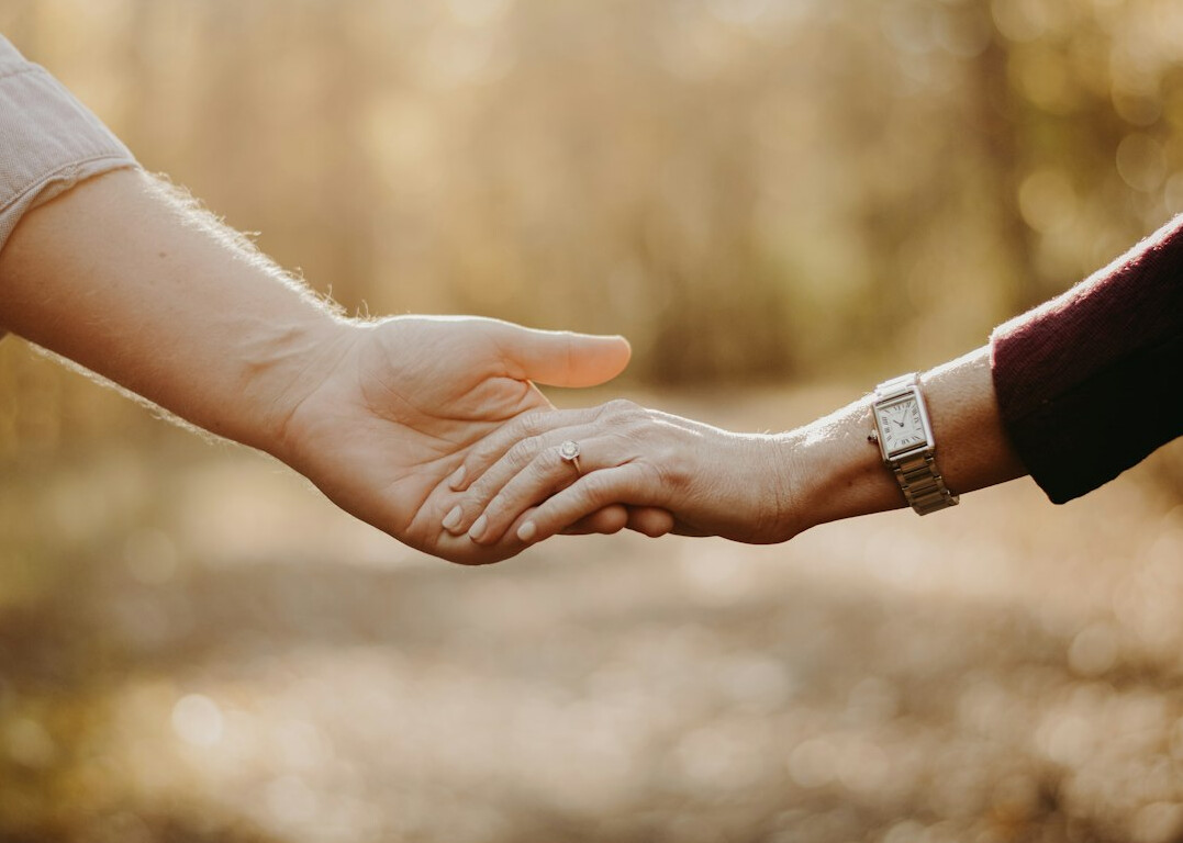 couple holding hands and talking